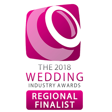 A pink and white logo for The 2018 Wedding Industry Awards, featuring text that reads The 2018 Wedding Industry Awards and a magenta button below stating Regional Finalist, showcases Heitman House, a renowned waterfront wedding venue. A pink and white logo for The 2018 Wedding Industry Awards, featuring text that reads The 2018 Wedding Industry Awards and a magenta button below stating Regional Finalist, showcases Heitman House, a renowned waterfront wedding venue.